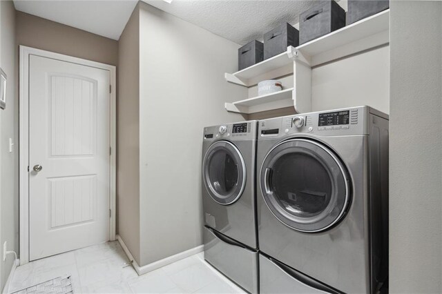 1220 Kingsland Cir, Raymore, MO 64083 - laundry room featuring washing machine and dryer and light marble finish floors