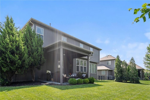 1220 Kingsland Cir, Raymore, MO 64083 - back of house featuring a patio area and an outdoor hangout area