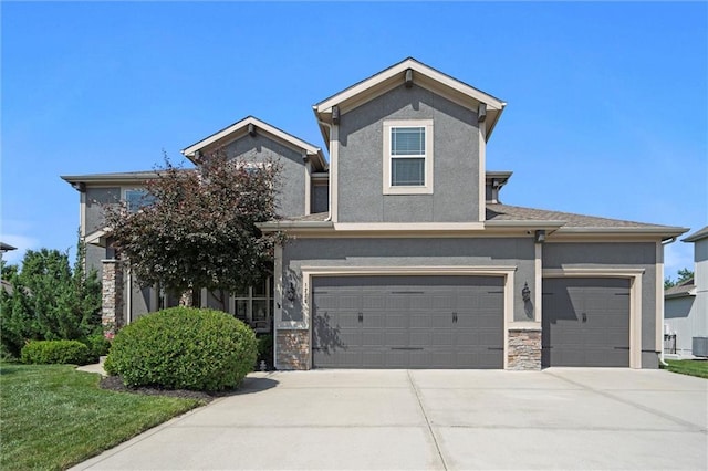 1220 Kingsland Cir, Raymore, MO 64083 - view of front of house with concrete driveway, stucco siding, stone siding, and an attached garage