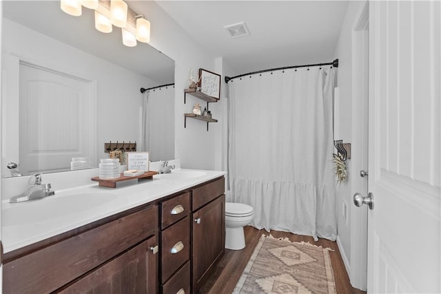 27104 E Cedar Grove Dr, Lees Summit, MO 64086 - full bathroom featuring double vanity, wood finished floors, and toilet