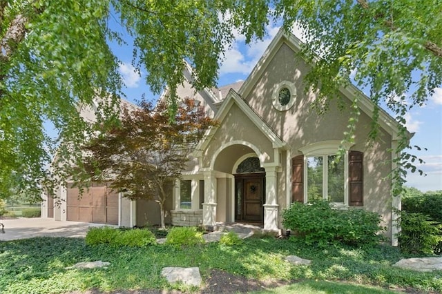 14605 Dearborn St, Overland Park, KS 66223 - view of front of house with concrete driveway, a garage, and stucco siding