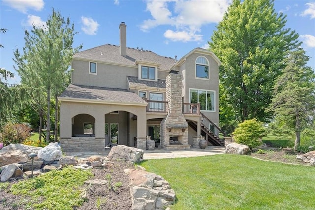 14605 Dearborn St, Overland Park, KS 66223 - back of house with stucco siding, stairway, a lawn, stone siding, and a chimney