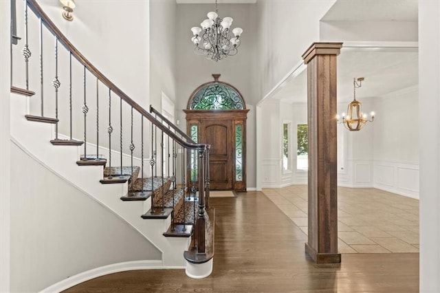 14605 Dearborn St, Overland Park, KS 66223 - foyer with a chandelier, a towering ceiling, a decorative wall, stairway, and wood finished floors
