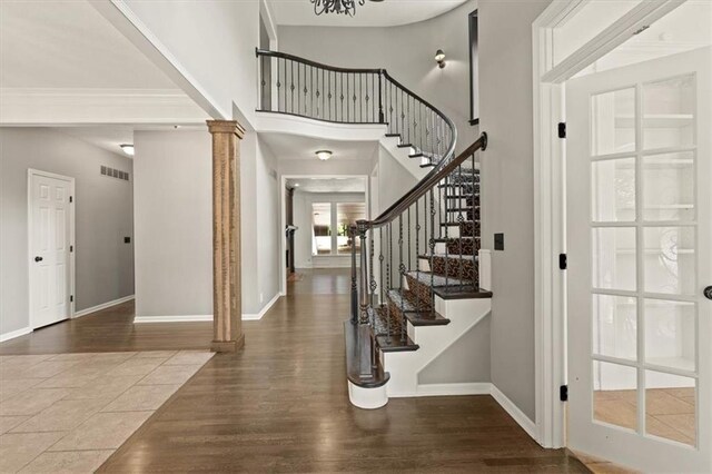 14605 Dearborn St, Overland Park, KS 66223 - entrance foyer with decorative columns, wood finished floors, stairs, a high ceiling, and crown molding