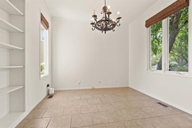 14605 Dearborn St, Overland Park, KS 66223 - spare room with plenty of natural light, a chandelier, light tile patterned floors, built in shelves, and crown molding