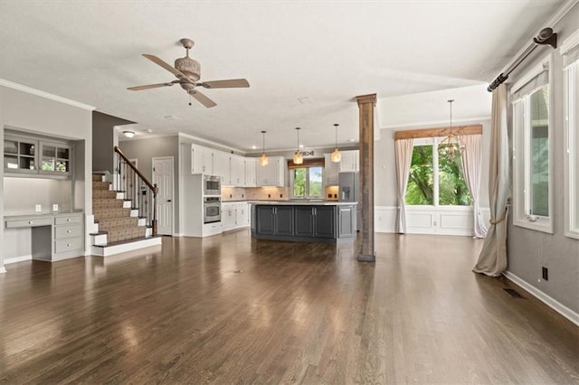 14605 Dearborn St, Overland Park, KS 66223 - unfurnished living room with dark wood-style floors, ceiling fan, stairs, and crown molding