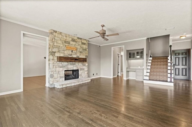14605 Dearborn St, Overland Park, KS 66223 - unfurnished living room featuring ceiling fan, ornamental molding, wood finished floors, a fireplace, and stairs
