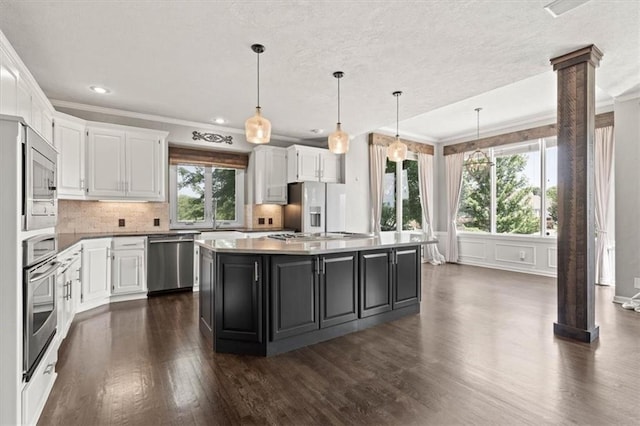 14605 Dearborn St, Overland Park, KS 66223 - kitchen with stainless steel appliances, white cabinets, dark wood-style flooring, ornamental molding, and recessed lighting