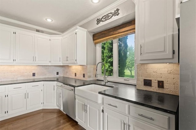 14605 Dearborn St, Overland Park, KS 66223 - kitchen featuring dishwasher, dark countertops, white cabinets, crown molding, and tasteful backsplash