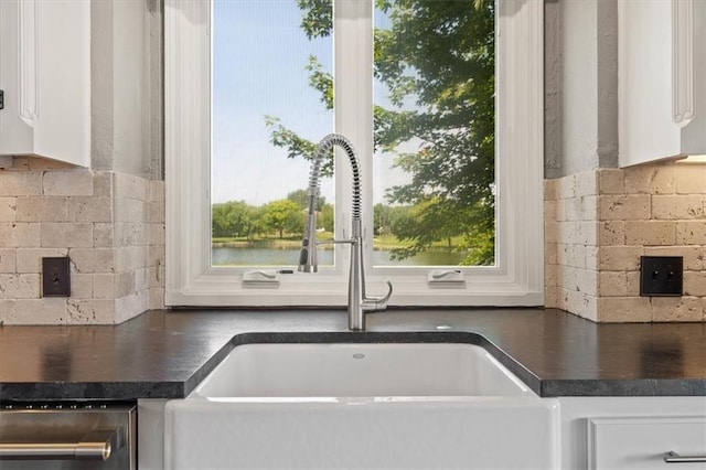 14605 Dearborn St, Overland Park, KS 66223 - kitchen with dark countertops, white cabinets, backsplash, and healthy amount of natural light