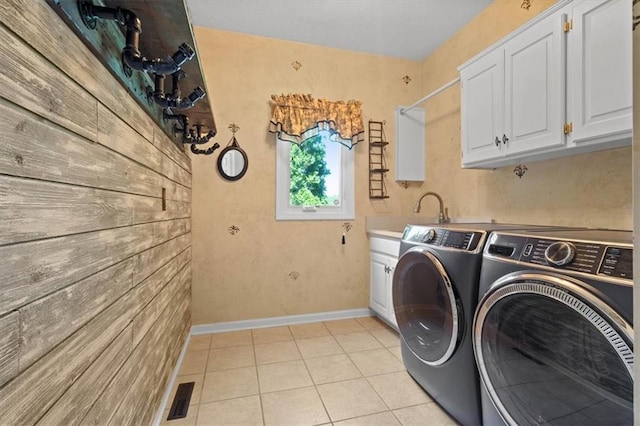 14605 Dearborn St, Overland Park, KS 66223 - laundry room featuring independent washer and dryer, cabinet space, and light tile patterned floors