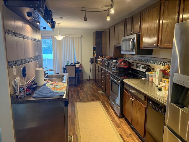 6521 W 49th St, Mission, KS 66202 - kitchen with stainless steel appliances, dark wood finished floors, a sink, dark countertops, and tasteful backsplash