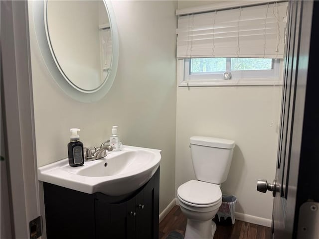 6521 W 49th St, Mission, KS 66202 - bathroom featuring vanity, baseboards, wood finished floors, and toilet