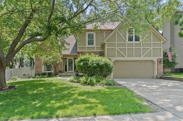 14105 W 115th St, Olathe, KS 66062 - english style home featuring concrete driveway, stucco siding, a garage, brick siding, and roof with shingles
