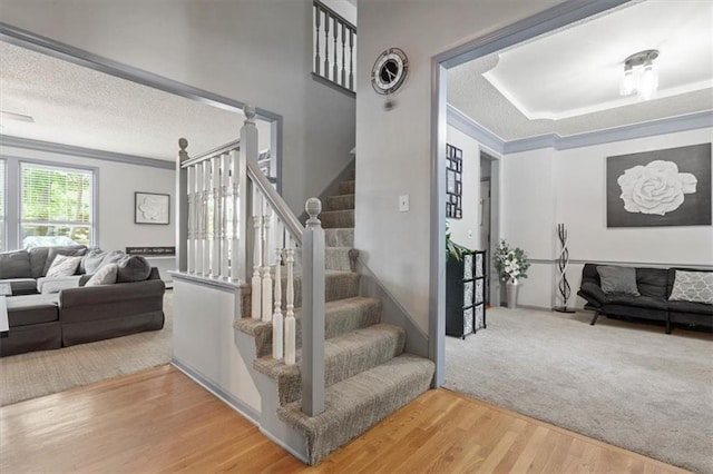 14105 W 115th St, Olathe, KS 66062 - stairs with wood finished floors, ornamental molding, and a textured ceiling