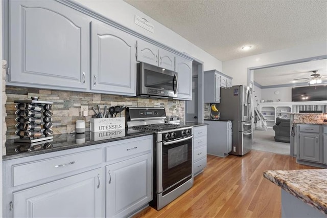 14105 W 115th St, Olathe, KS 66062 - kitchen with stainless steel appliances, gray cabinetry, a textured ceiling, light wood-type flooring, and a ceiling fan