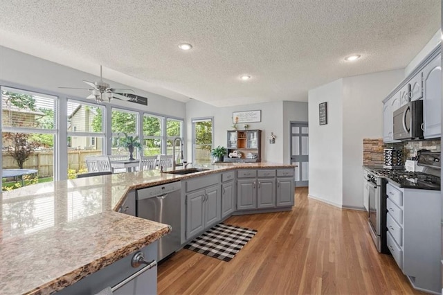 14105 W 115th St, Olathe, KS 66062 - kitchen with appliances with stainless steel finishes, gray cabinets, a textured ceiling, ceiling fan, and light wood-style flooring