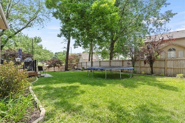 14105 W 115th St, Olathe, KS 66062 - view of yard with a trampoline and a deck