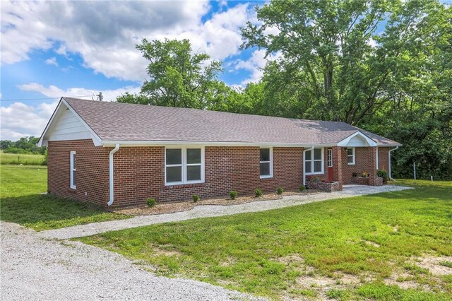 1129 US Highway 50, Centerview, MO 64019 - ranch-style home featuring brick siding, a front yard, and roof with shingles