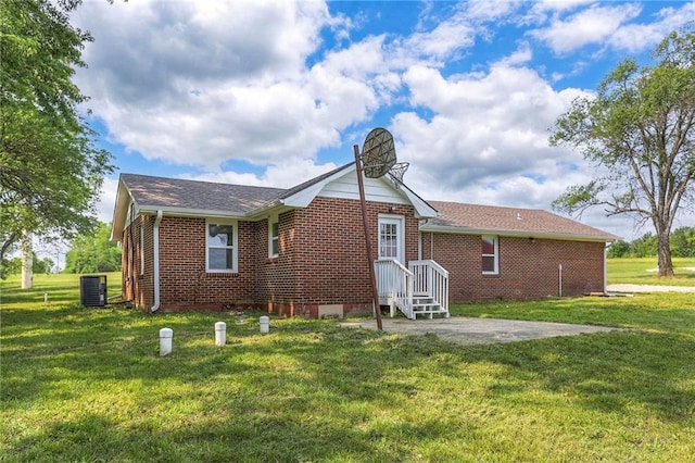 1129 US Highway 50, Centerview, MO 64019 - back of house with brick siding, a lawn, and roof with shingles