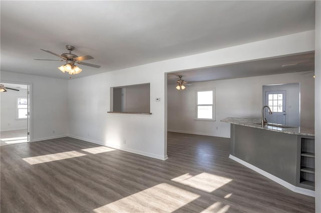 1129 US Highway 50, Centerview, MO 64019 - unfurnished living room featuring a ceiling fan and dark wood-style floors