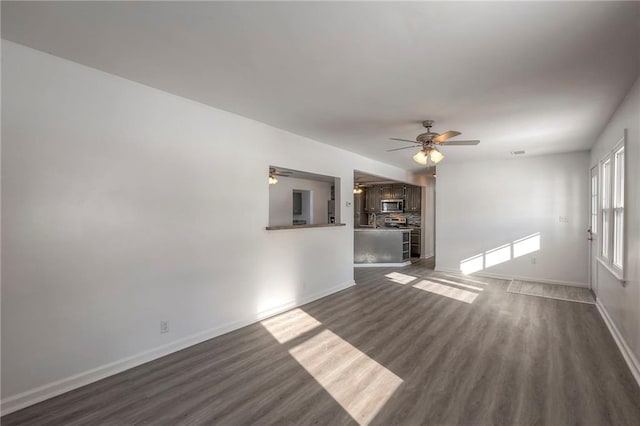 1129 US Highway 50, Centerview, MO 64019 - unfurnished living room featuring ceiling fan and dark wood-type flooring