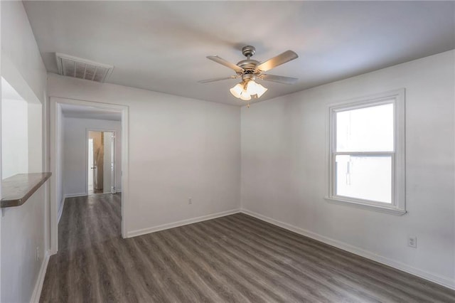 1129 US Highway 50, Centerview, MO 64019 - spare room featuring dark wood-style flooring and ceiling fan