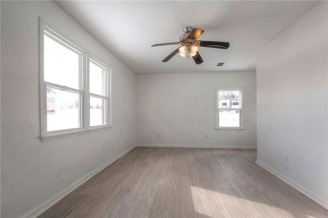 1129 US Highway 50, Centerview, MO 64019 - empty room with light wood finished floors and ceiling fan