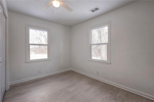 1129 US Highway 50, Centerview, MO 64019 - empty room with wood finished floors, a ceiling fan, and a textured ceiling
