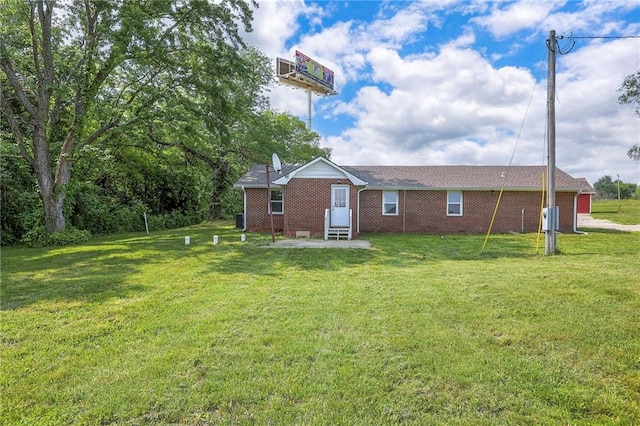 1129 US Highway 50, Centerview, MO 64019 - back of property featuring a yard, entry steps, and brick siding