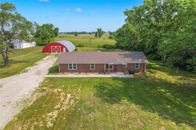 1129 US Highway 50, Centerview, MO 64019 - view of front of property featuring a barn, gravel driveway, an outdoor structure, a front lawn, and brick siding