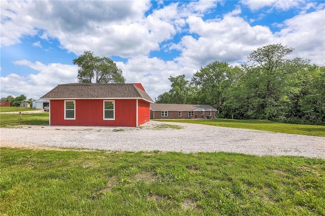 1129 US Highway 50, Centerview, MO 64019 - view of side of property featuring a lawn, an outdoor structure, and driveway