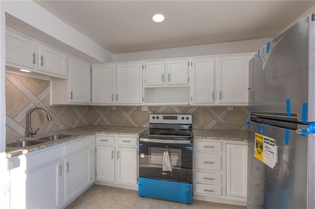 1129 US Highway 50, Centerview, MO 64019 - kitchen featuring stainless steel appliances, white cabinetry, tasteful backsplash, light stone countertops, and recessed lighting