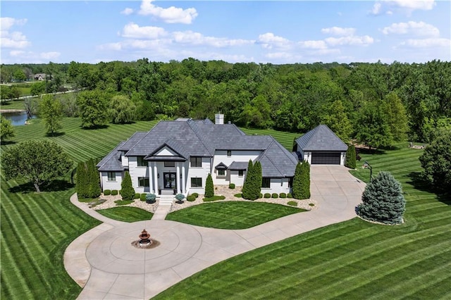 20711 Benson St, Bucyrus, KS 66013 - french country style house featuring a front yard, a chimney, and a detached garage