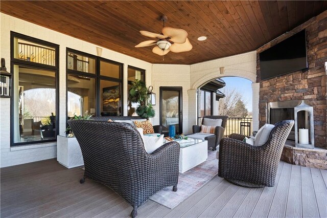 20711 Benson St, Bucyrus, KS 66013 - wooden deck with an outdoor living space with a fireplace and a ceiling fan