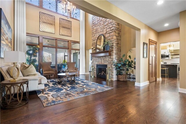 20711 Benson St, Bucyrus, KS 66013 - living room with wood finished floors, a fireplace, recessed lighting, and a chandelier