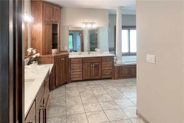 20711 Benson St, Bucyrus, KS 66013 - full bath with ornate columns, vanity, a shower stall, and tile patterned flooring
