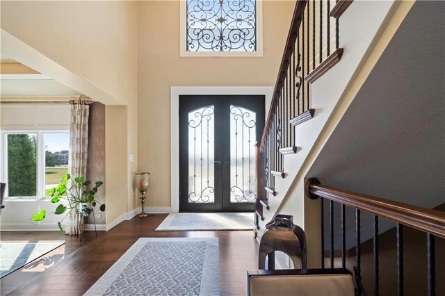20711 Benson St, Bucyrus, KS 66013 - foyer with a high ceiling, french doors, stairs, and wood finished floors