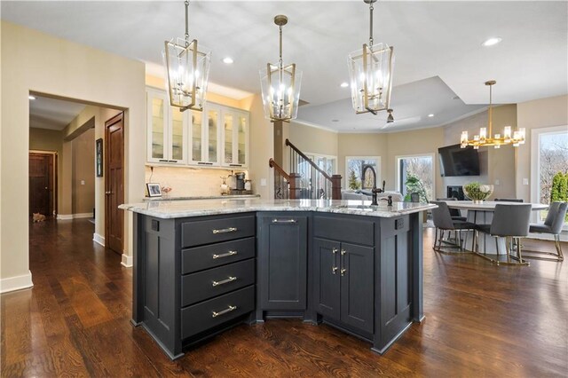 20711 Benson St, Bucyrus, KS 66013 - kitchen featuring a chandelier, healthy amount of natural light, recessed lighting, a center island, and light stone counters