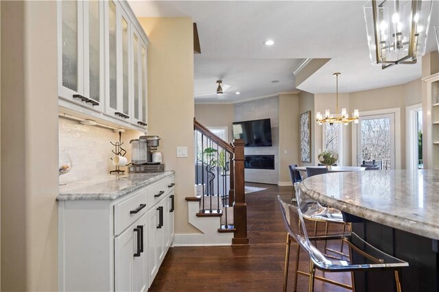 20711 Benson St, Bucyrus, KS 66013 - kitchen with a chandelier, plenty of natural light, light stone counters, dark wood-type flooring, and recessed lighting