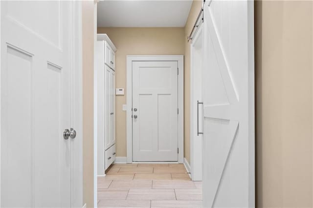 20711 Benson St, Bucyrus, KS 66013 - doorway to outside featuring wood finish floors and a barn door