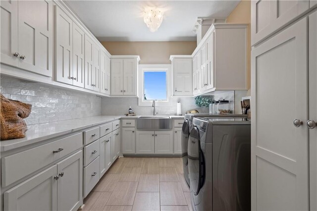 20711 Benson St, Bucyrus, KS 66013 - washroom with washing machine and clothes dryer and cabinet space
