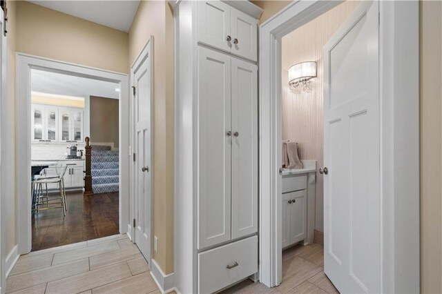 20711 Benson St, Bucyrus, KS 66013 - corridor featuring light wood-style flooring