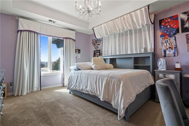 20711 Benson St, Bucyrus, KS 66013 - carpeted bedroom with a chandelier and a tray ceiling