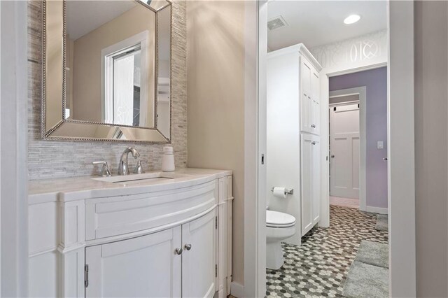 20711 Benson St, Bucyrus, KS 66013 - bathroom featuring tile patterned floors, vanity, and backsplash