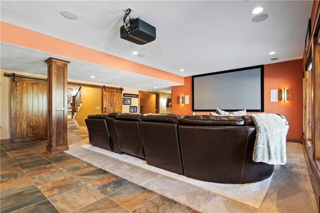 20711 Benson St, Bucyrus, KS 66013 - home theater with a barn door, decorative columns, stone tile flooring, and recessed lighting