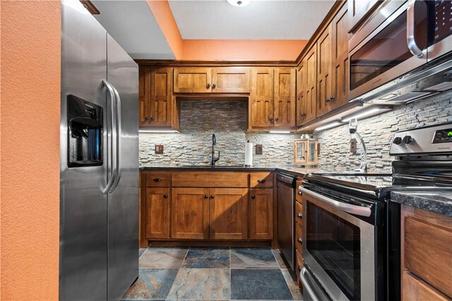 20711 Benson St, Bucyrus, KS 66013 - kitchen with appliances with stainless steel finishes, decorative backsplash, stone finish flooring, and brown cabinets