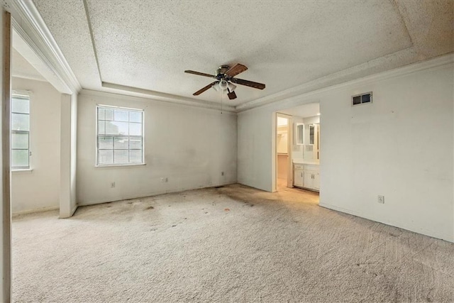 11431 Reeder St, Overland Park, KS 66210 - empty room with a raised ceiling, a ceiling fan, a textured ceiling, ornamental molding, and carpet flooring