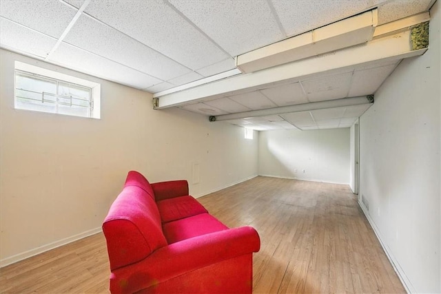 11431 Reeder St, Overland Park, KS 66210 - living area with a drop ceiling, wood finished floors, and baseboards