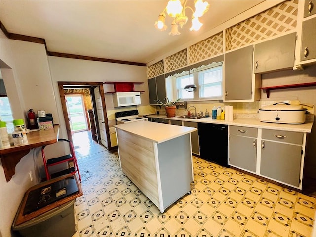 107 W 23rd St, Higginsville, MO 64037 - kitchen with white appliances, light countertops, light floors, crown molding, and a chandelier